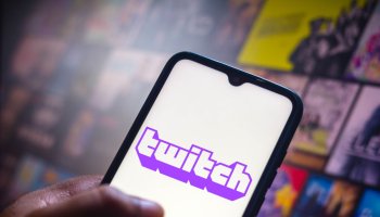 In this photo illustration the Twitch logo seen displayed on...