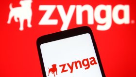 In this photo illustration a Zynga logo of the U.S. social...