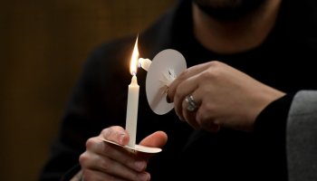 Attendees light candles as the names of the victims were read.Moms Demand Action for Gun Safety organized a memorial on the fifth anniversary of the Sandy Hook Elementary School shooting. The small service was held at Reform Congregation Oheb Shalom