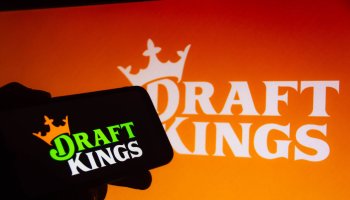 In this photo illustration the DraftKings logo seen...