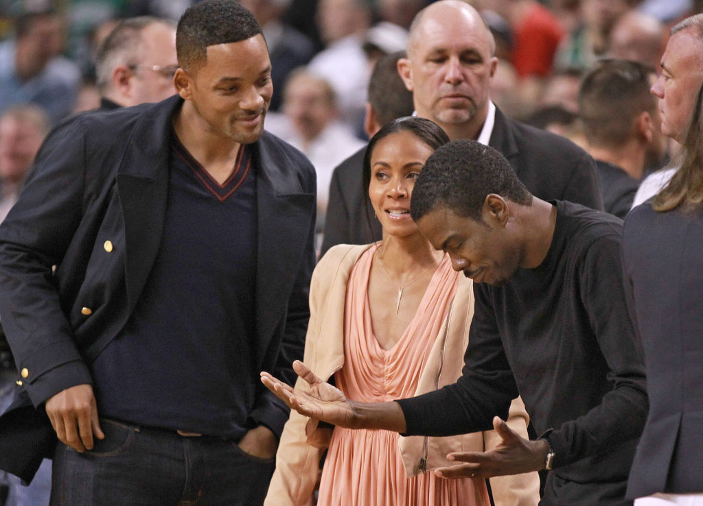 Boston, MA - Comedian/actor Chris Rock, right, chats with Will Smith and Jada Pinkett-Smith at Game 5 of the Eastern Conference Semifinals at TD Garden on Monday, May 21, 2012. Staff Photo by Matthew West.