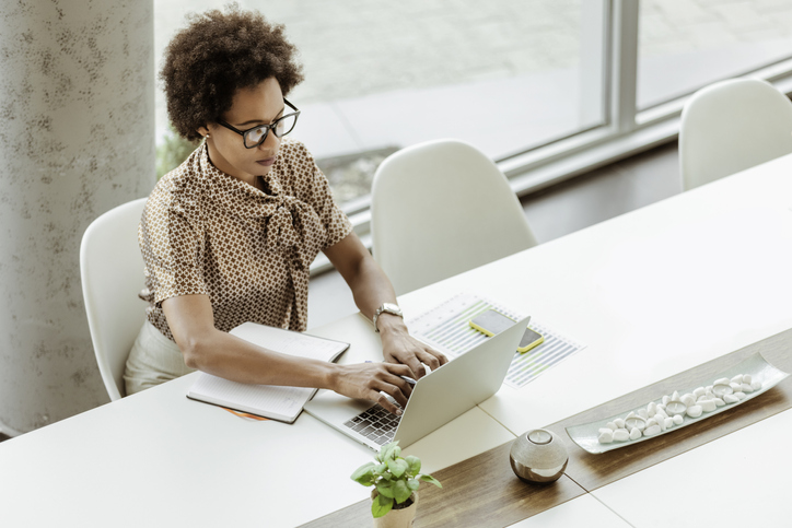 Racism In Metaverse - Business Woman Working on Laptop Computer in the Office