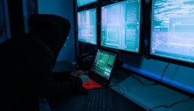 Asian female hacker wearing black mask in the server room for internet attack.