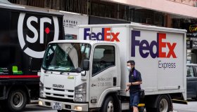 A worker of the American FedEx Express delivery is seen...