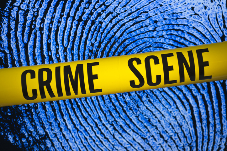 Crime scene tape in front of fingerprint