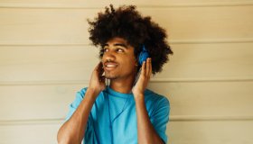 African american man with african hairstyle listening music