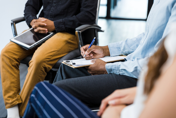 Unrecognizable people meet with male therapist