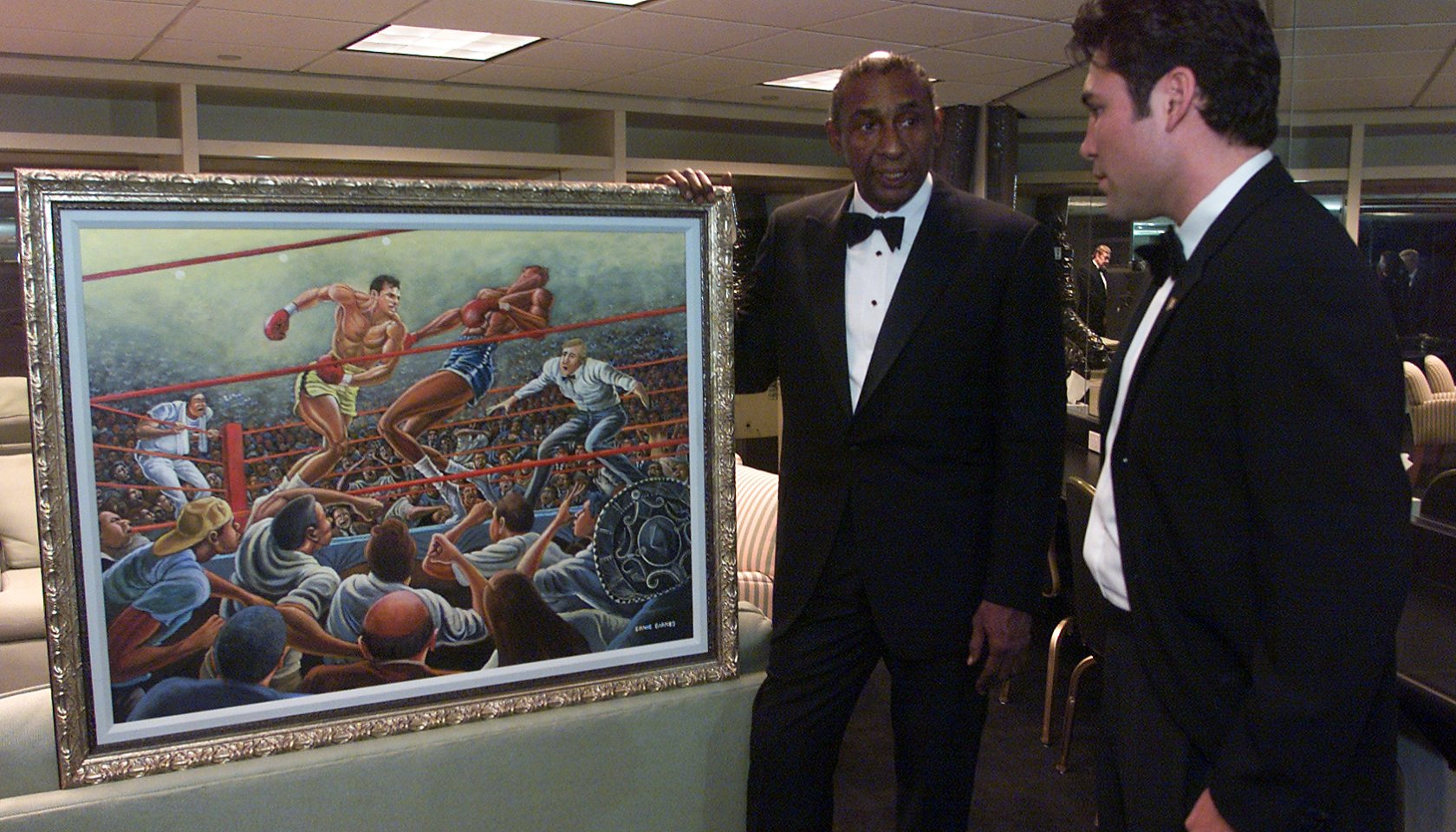 12/12/2001  Ernie Barnes, left, former NFL player now an accomplished artist, shows a painting comm