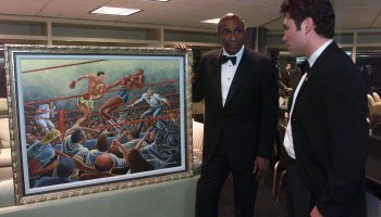 12/12/2001  Ernie Barnes, left, former NFL player now an accomplished artist, shows a painting comm