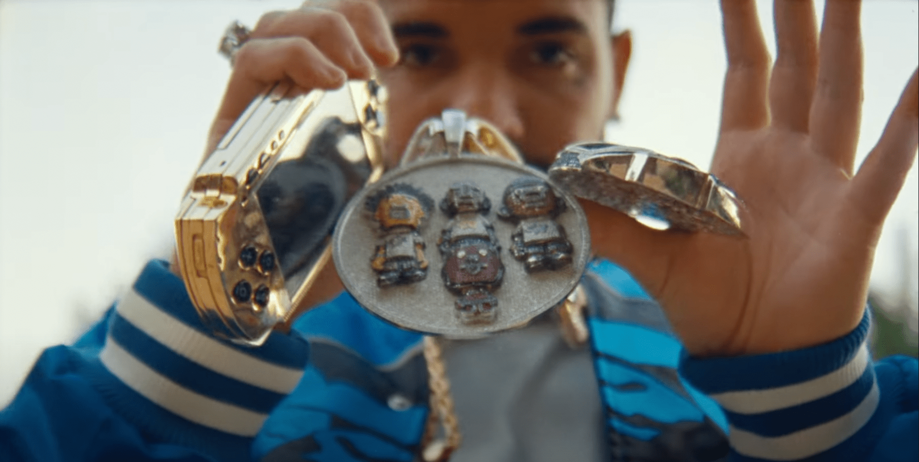 Drake Stunts With Pharrell's Gold PSP In New Music Video