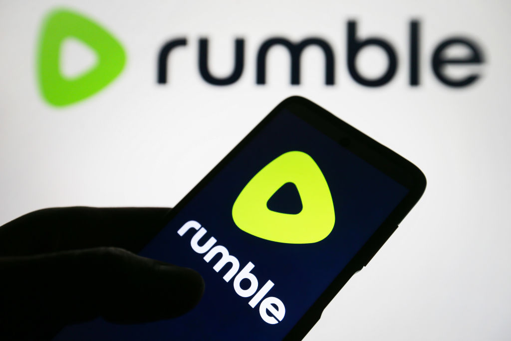 In this photo illustration, a Rumble logo is seen on a...