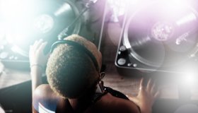 Black woman, DJ and music for party, club or event in celebration, sound or energy with technology. African American female musician with turntable for disco, concert or audio track at nightclub