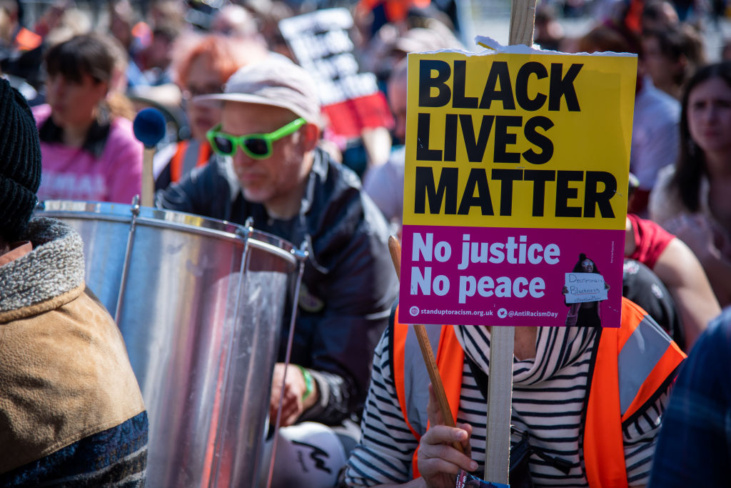 A placard is seen amongst the crowd of activists during the...