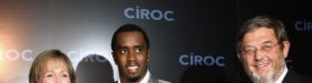 Sean "Diddy" Combs (C) holds a bottle of