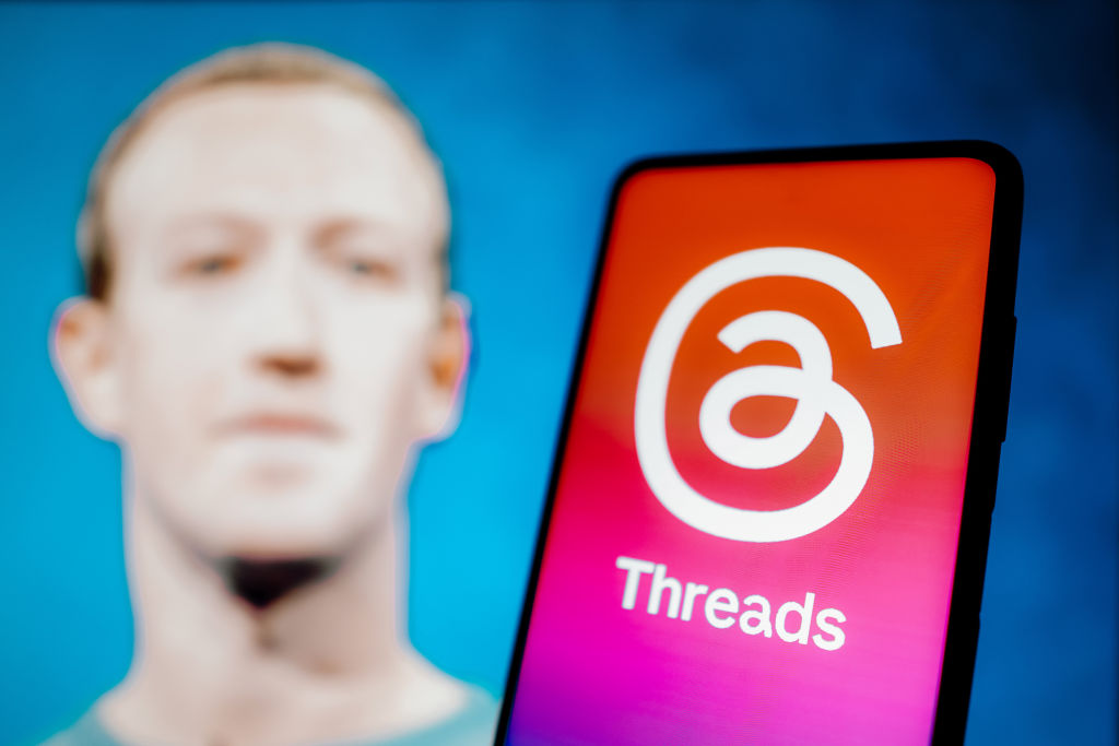 In this photo illustration, the Threads logo is displayed on...