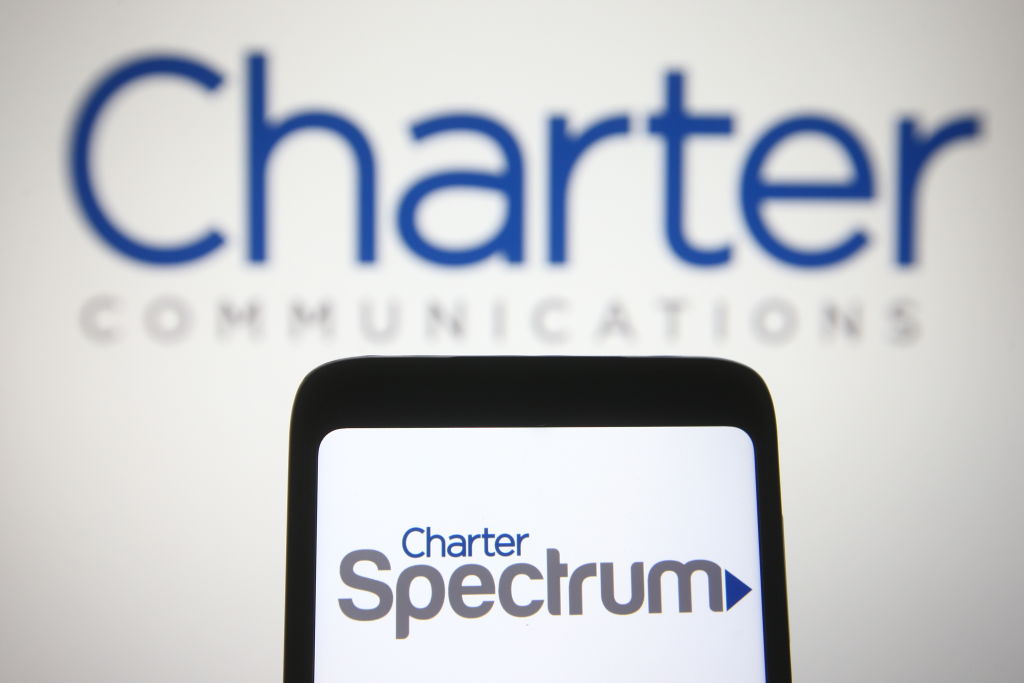 In this photo illustration the Charter Spectrum logo seen on...