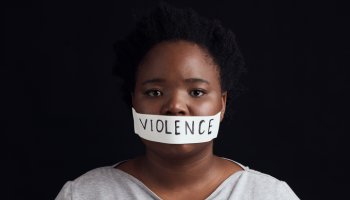 Portrait, censorship and a black woman in protest of domestic violence on a dark background. Freedom, gender equality or empowerment with a serious young female person in studio for human rights