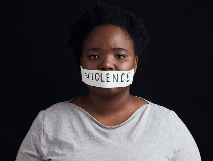 Portrait, censorship and a black woman in protest of domestic violence on a dark background. Freedom, gender equality or empowerment with a serious young female person in studio for human rights