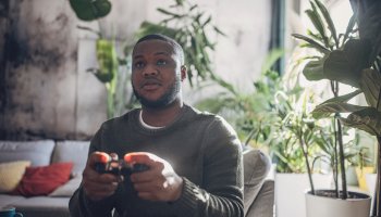 Focused Man Gaming Intensely on Console