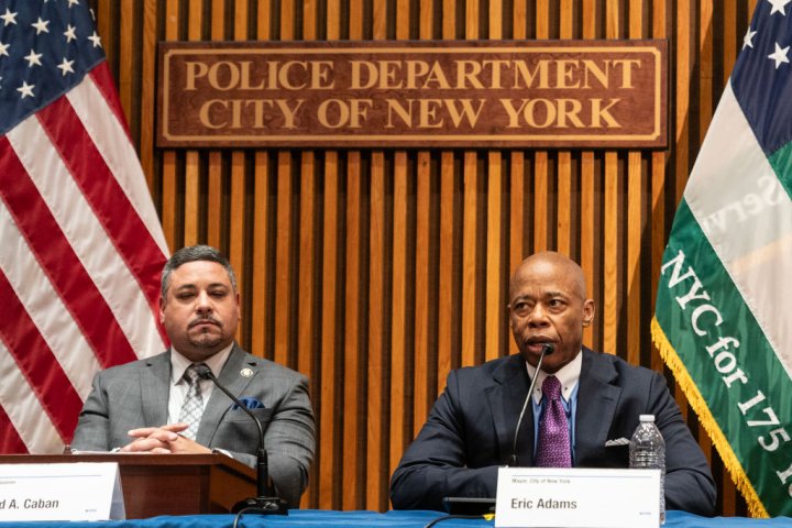 Mayor Eric Adams speaks as Police Commissioner Edward Caban...
