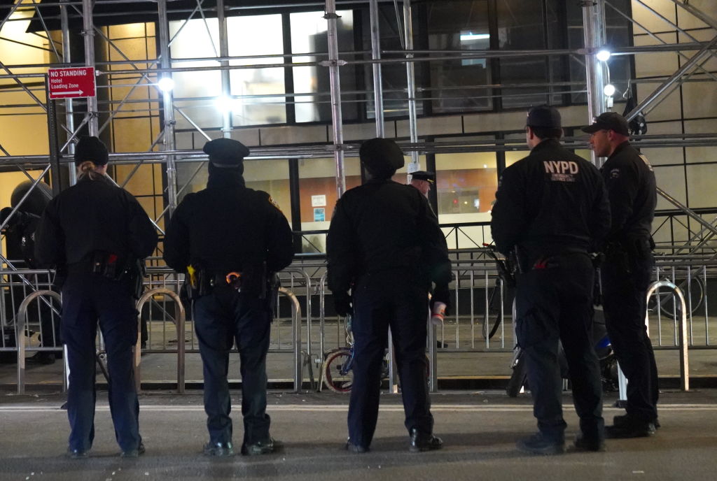 NYPD and sanitation crews clear migrants from Manhattan hotel sidewalk