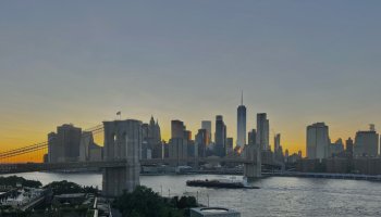 Manhattan Skyline during sunset from Brooklyn with clear view of Brooklyn Bridge