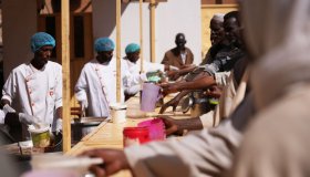 Civilians fleeing conflict in Sudan access hot meals in places called "lodge"