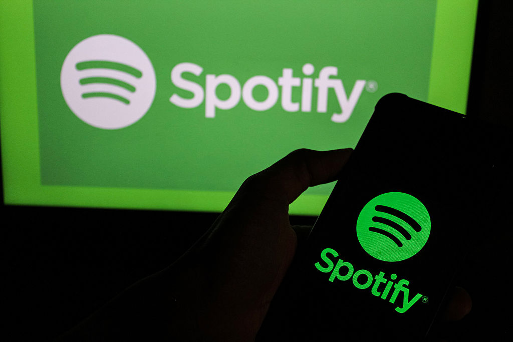 In this photo illustration, a Spotify logo is displayed on a...