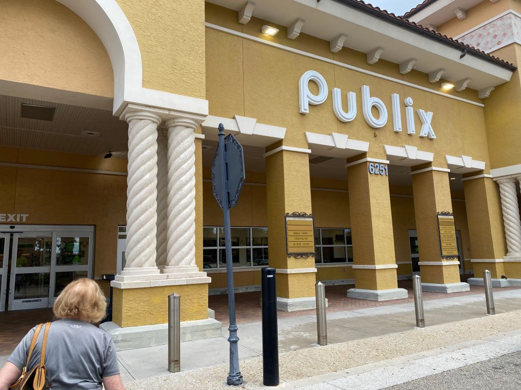 Senior, mature adult, woman, customer, entering, Publix, supermarket, West Palm Beach, Florida, building exterior, food, shopping, store