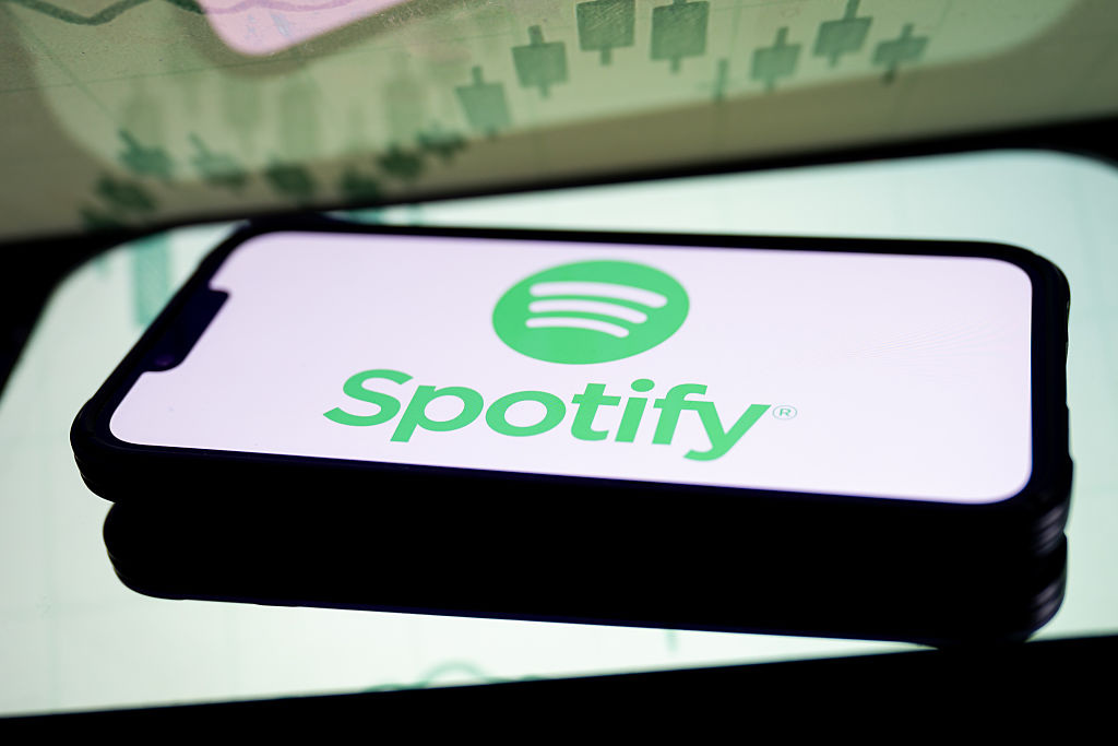 In this photo illustration, a Spotify logo seen displayed on...