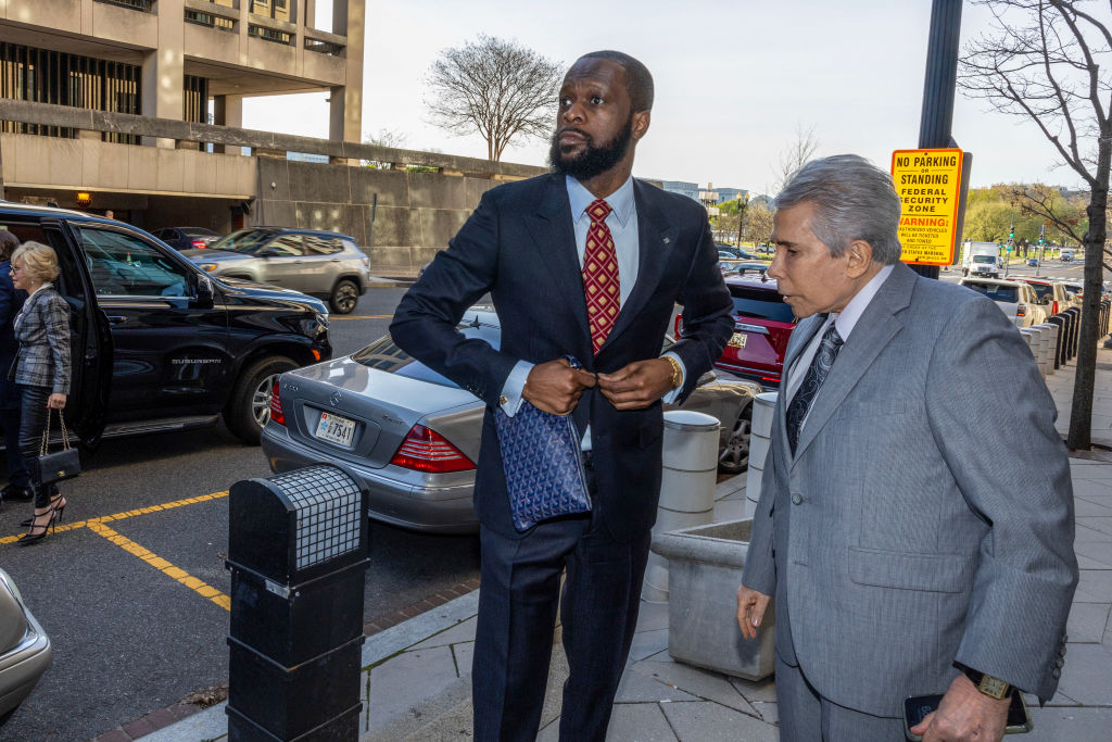Fugees member Pras Michel turned himself in to begin his 14-year prison sentence for money laundering and other charges.