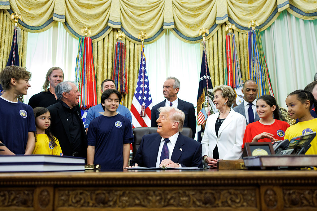  President Donald Trump speaks before sign