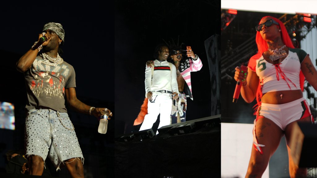 Performers on stage in colorful, stylized outfits singing into microphones during a concert or performance event.