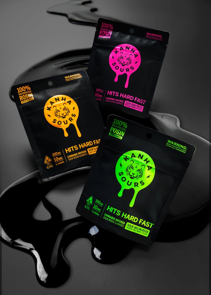 Assorted packages of cannabis-infused edibles labeled "Kanha Sours" with warnings and product details.
