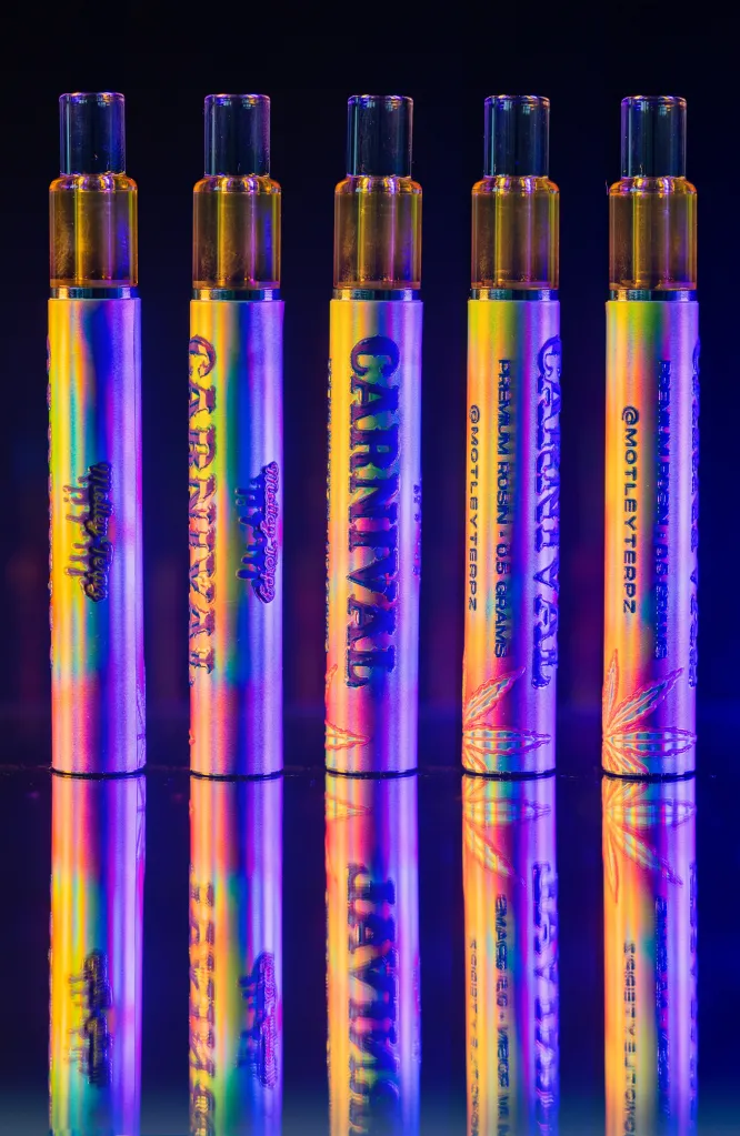 Colorful vape pens with various brand names and designs displayed against a dark background.