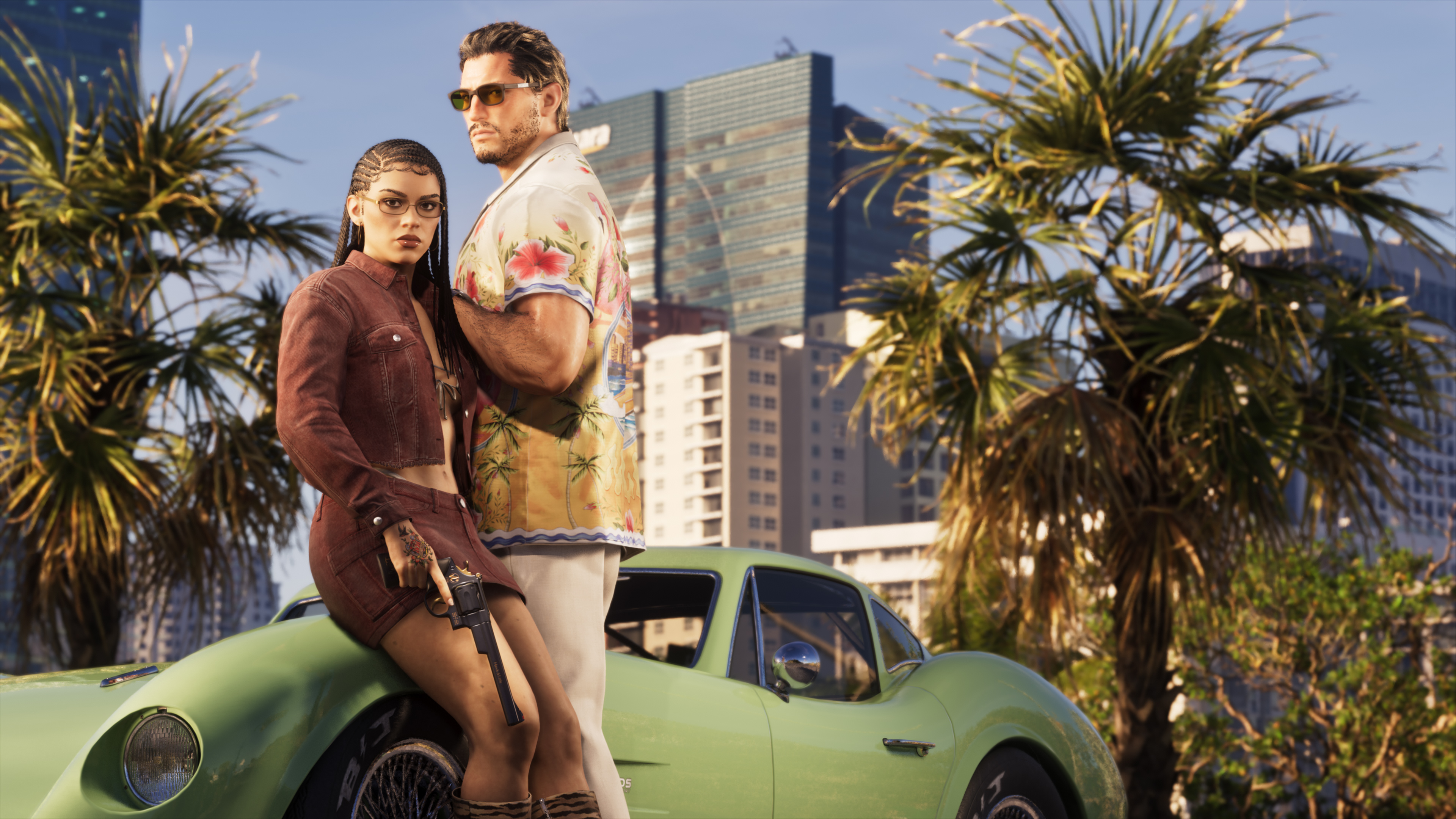 Two people standing in front of a green vintage car in a city with palm trees.