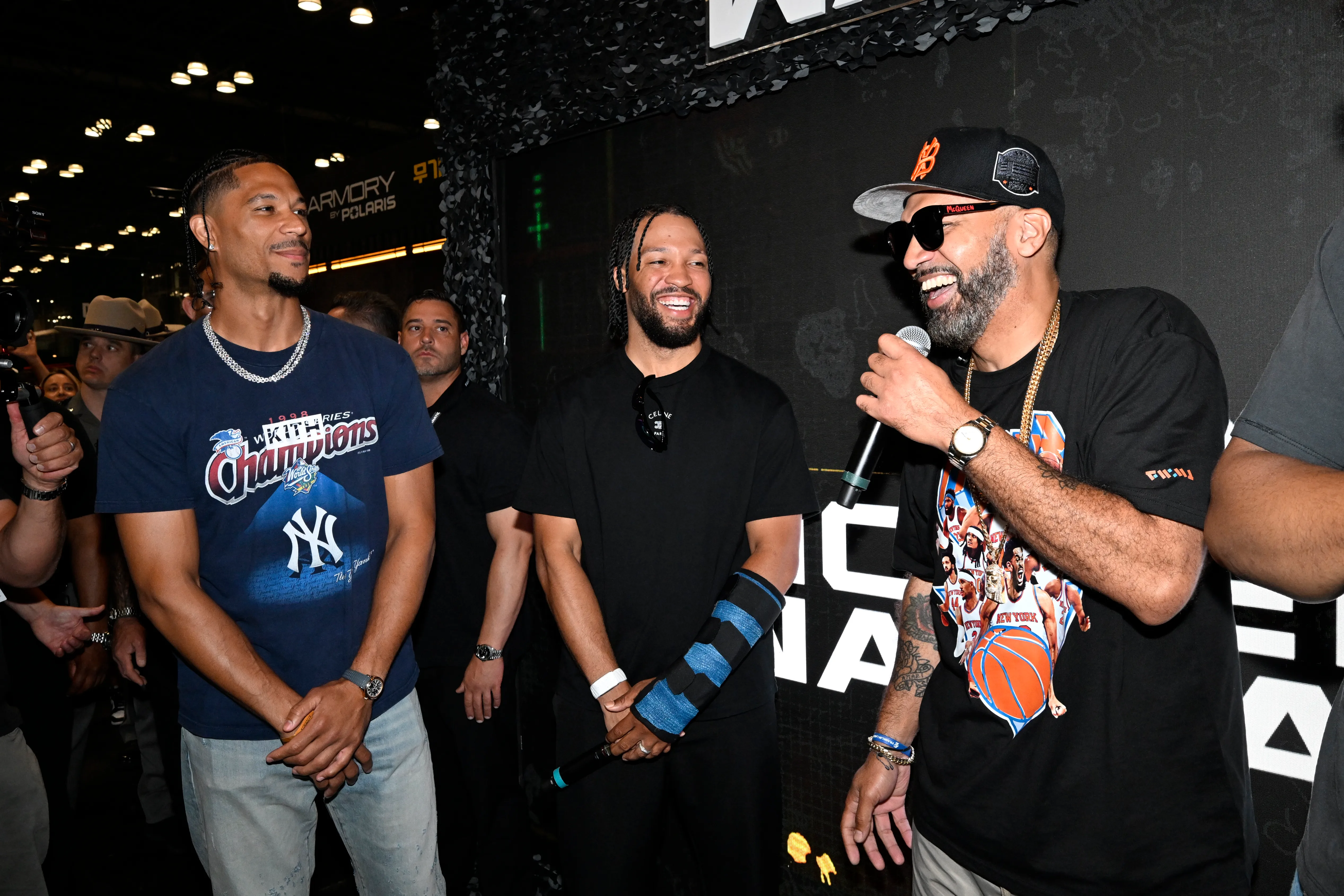 Three men, including a basketball player, a comedian, and another man, standing together and smiling at a Call of Duty event.