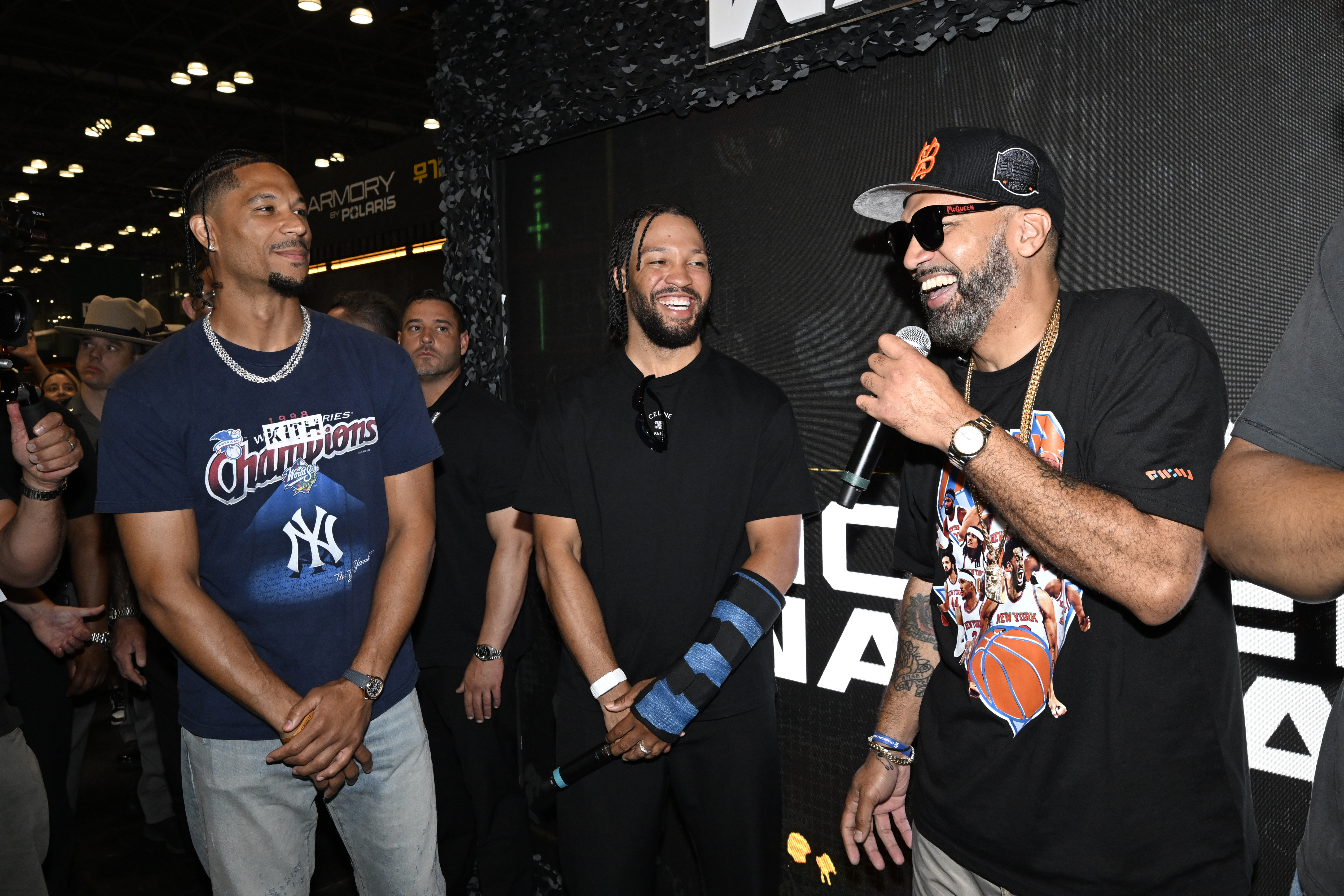 Three men, including a basketball player, a comedian, and another man, standing together and smiling at a Call of Duty event.