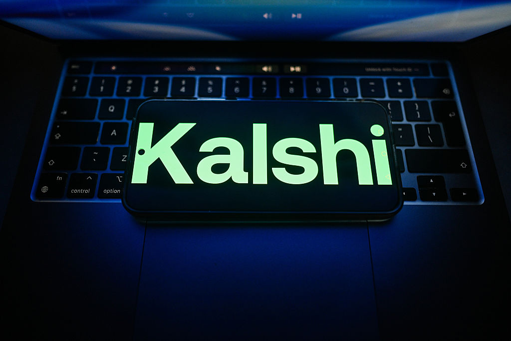 In this photo illustration, a Kalshi is seen logo displayed