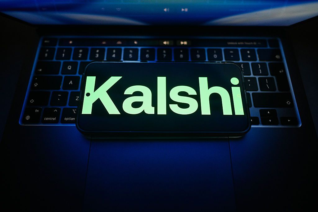 In this photo illustration, a Kalshi is seen logo displayed