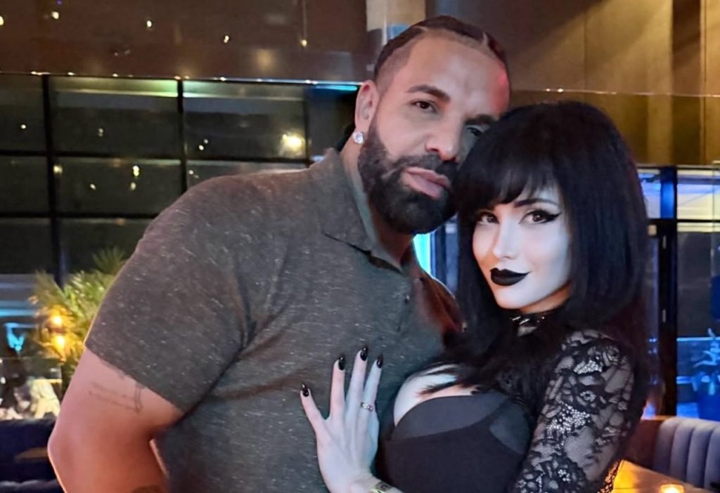 A man with a beard embracing a woman with dark hair in a dimly lit restaurant or bar setting.