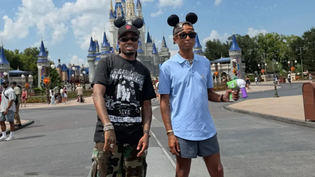 Two men wearing Mickey Mouse ear hats standing in front of Cinderella Castle at Walt Disney World.