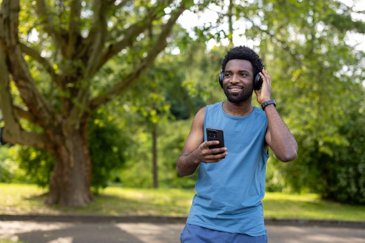 Happy man listening to music during outdoor workout