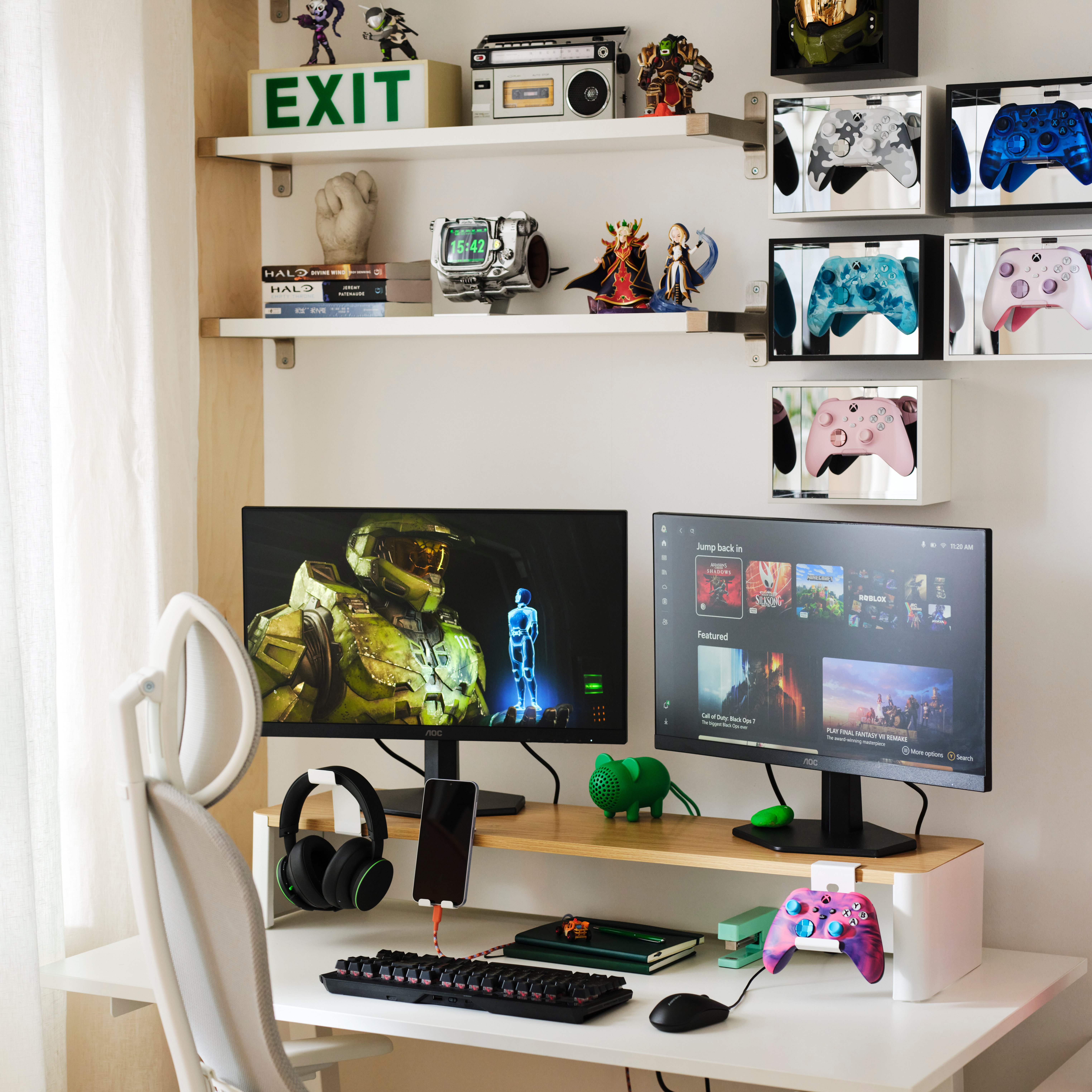 A gaming setup with a large monitor displaying a sci-fi video game, surrounded by game controllers, headphones, and shelves displaying video game memorabilia and accessories.