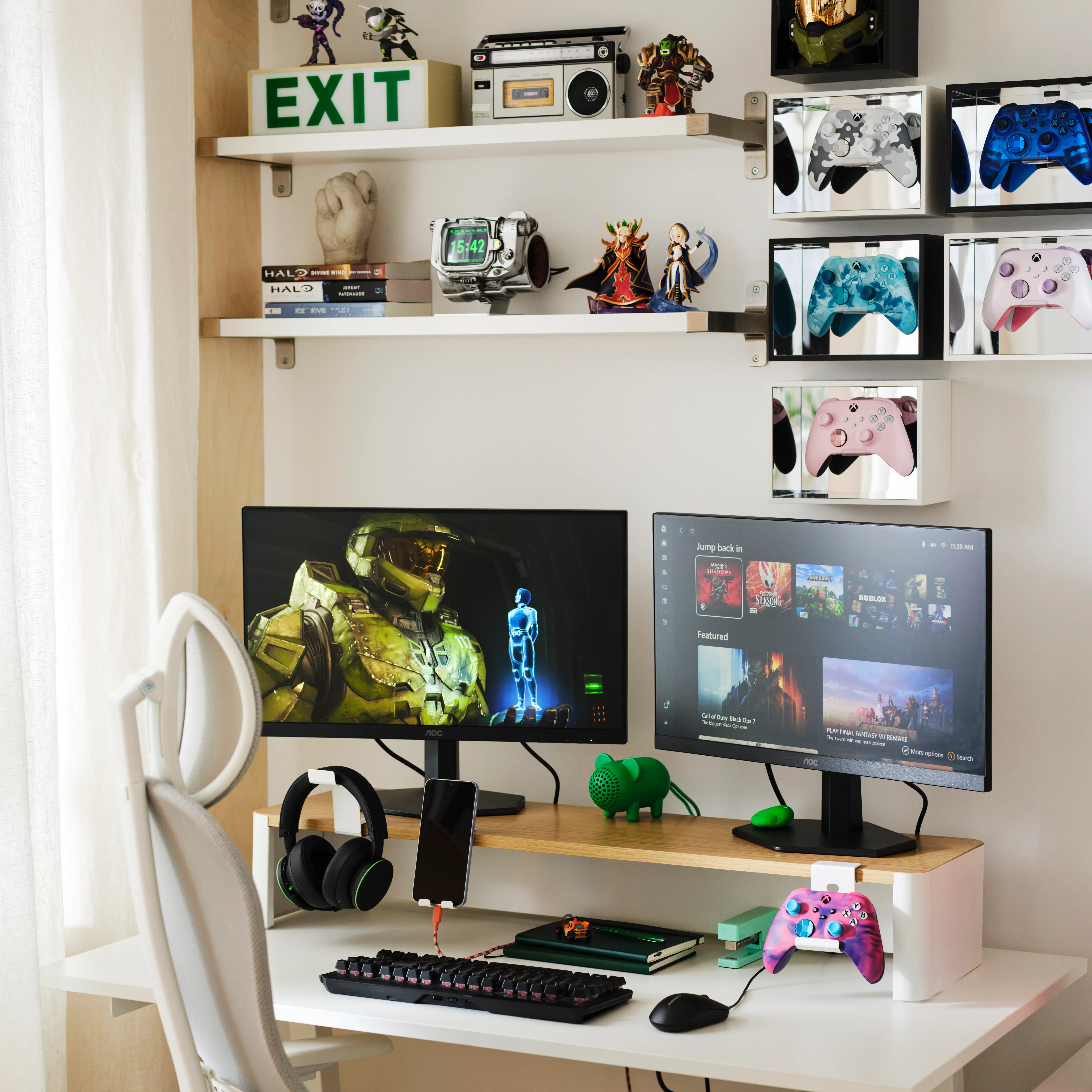 A gaming setup with a large monitor displaying a sci-fi video game, surrounded by game controllers, headphones, and shelves displaying video game memorabilia and accessories.