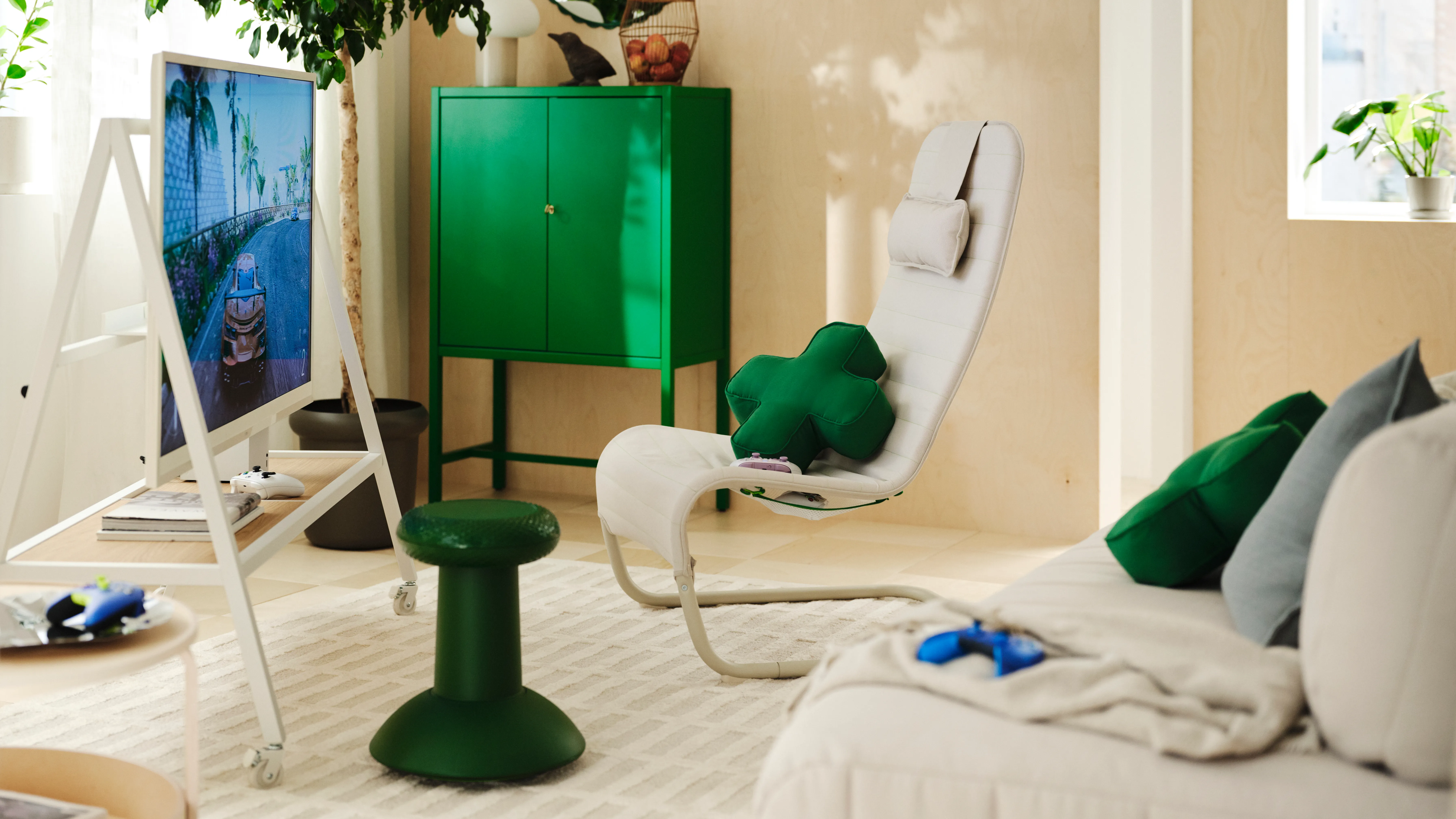 A cozy living room with a green cabinet, white chair, and various decorative elements like plants and artwork.