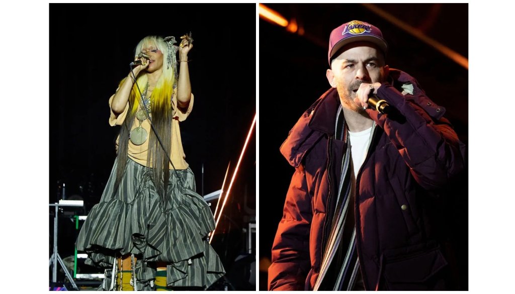 A woman with blonde hair and a colorful dress performing on stage, and a man with a beard wearing a red jacket and hat singing into a microphone on stage.